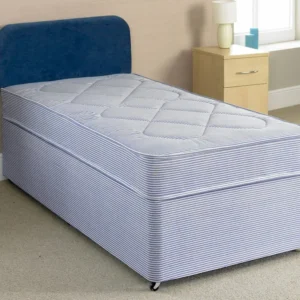 A divan bed set with pale blue mattress and dark blue headboard.
