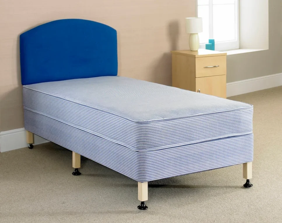 A bed with 6 legs and a blue mattress and headboard.