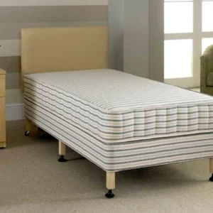 A bed with six legs and a cream headboard.