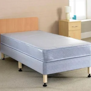 A bed with a wooden heardboard, six legs and a blue mattress.