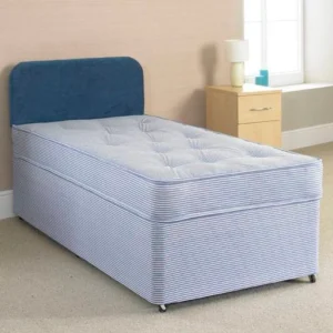 A divan bed with a blue mattress and headboard.